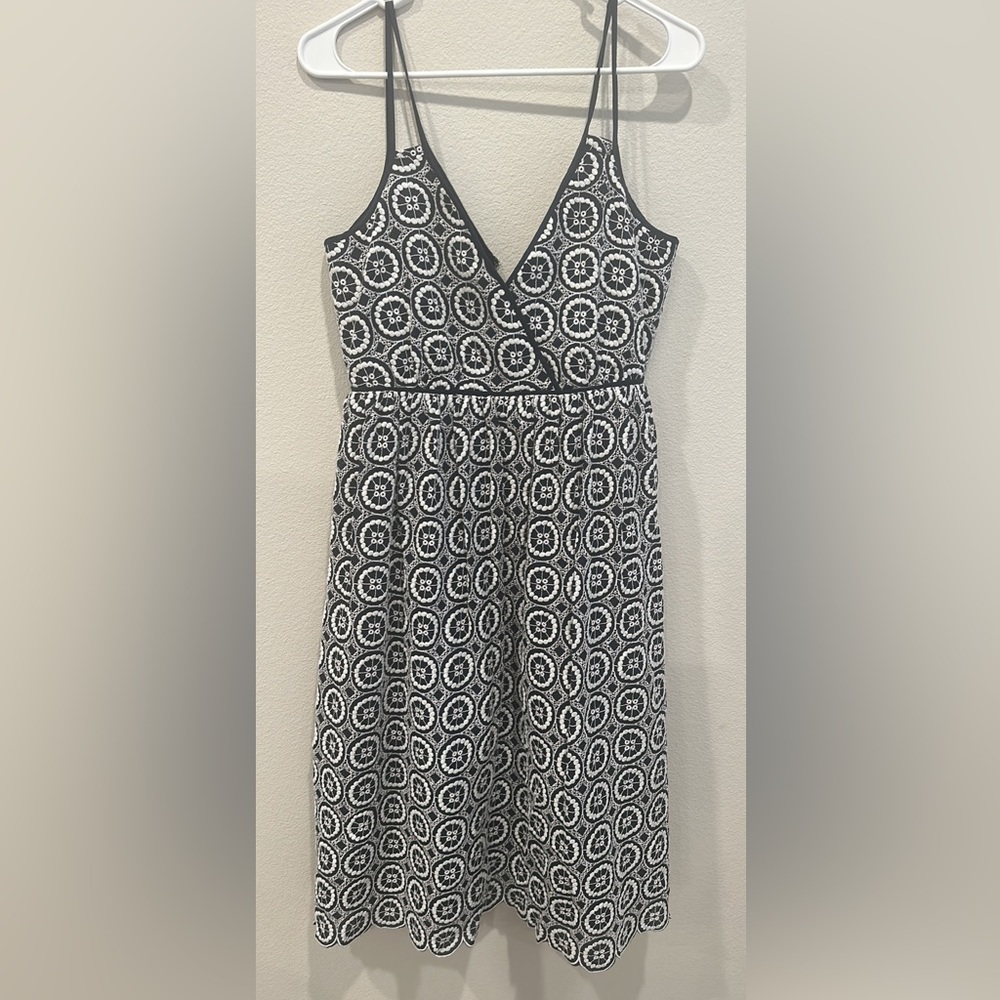 Navy dress with white detailing. Goes below the knees. For fancier occasion
